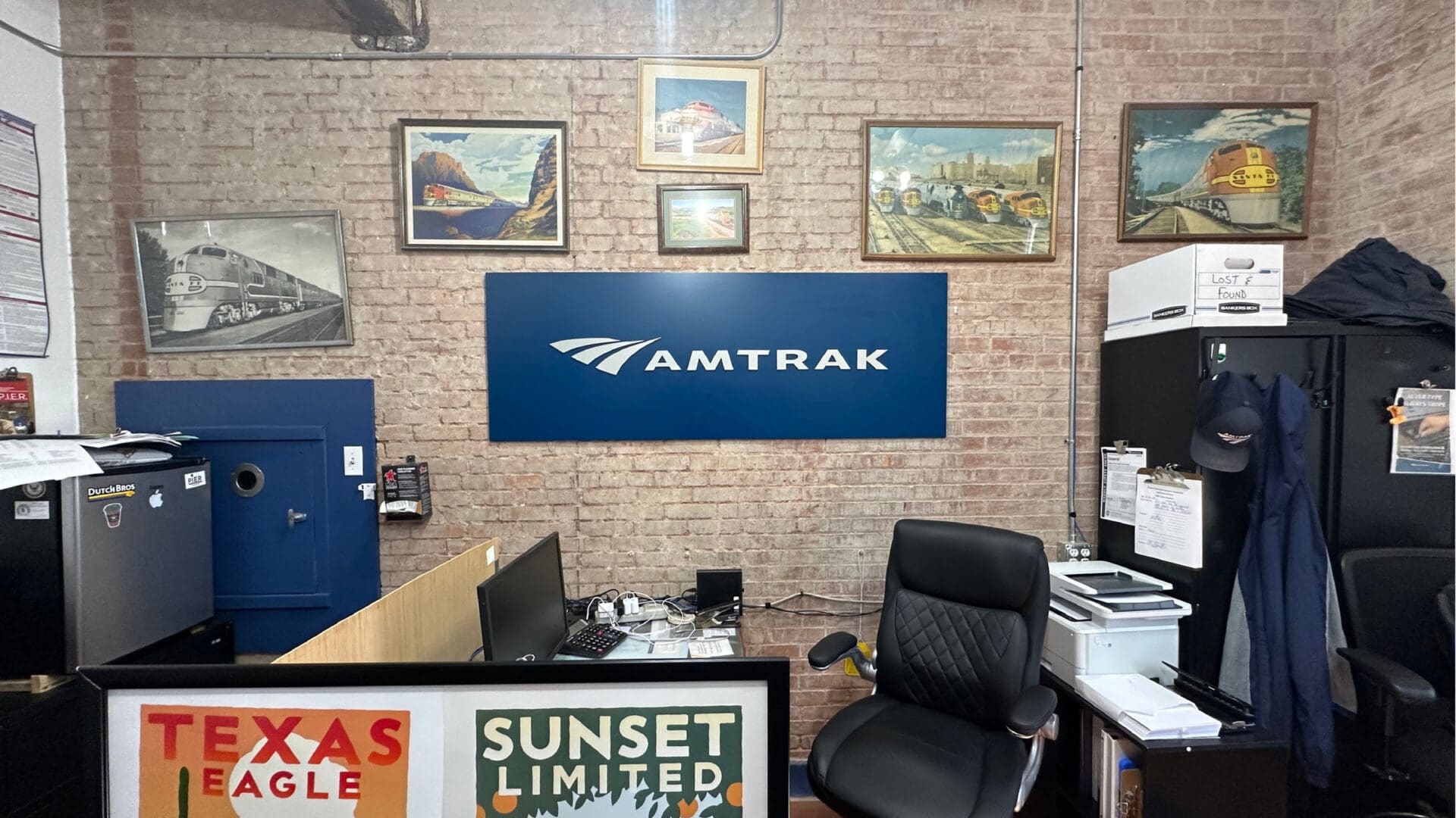 Amtrak blue logo sign on exposed brick