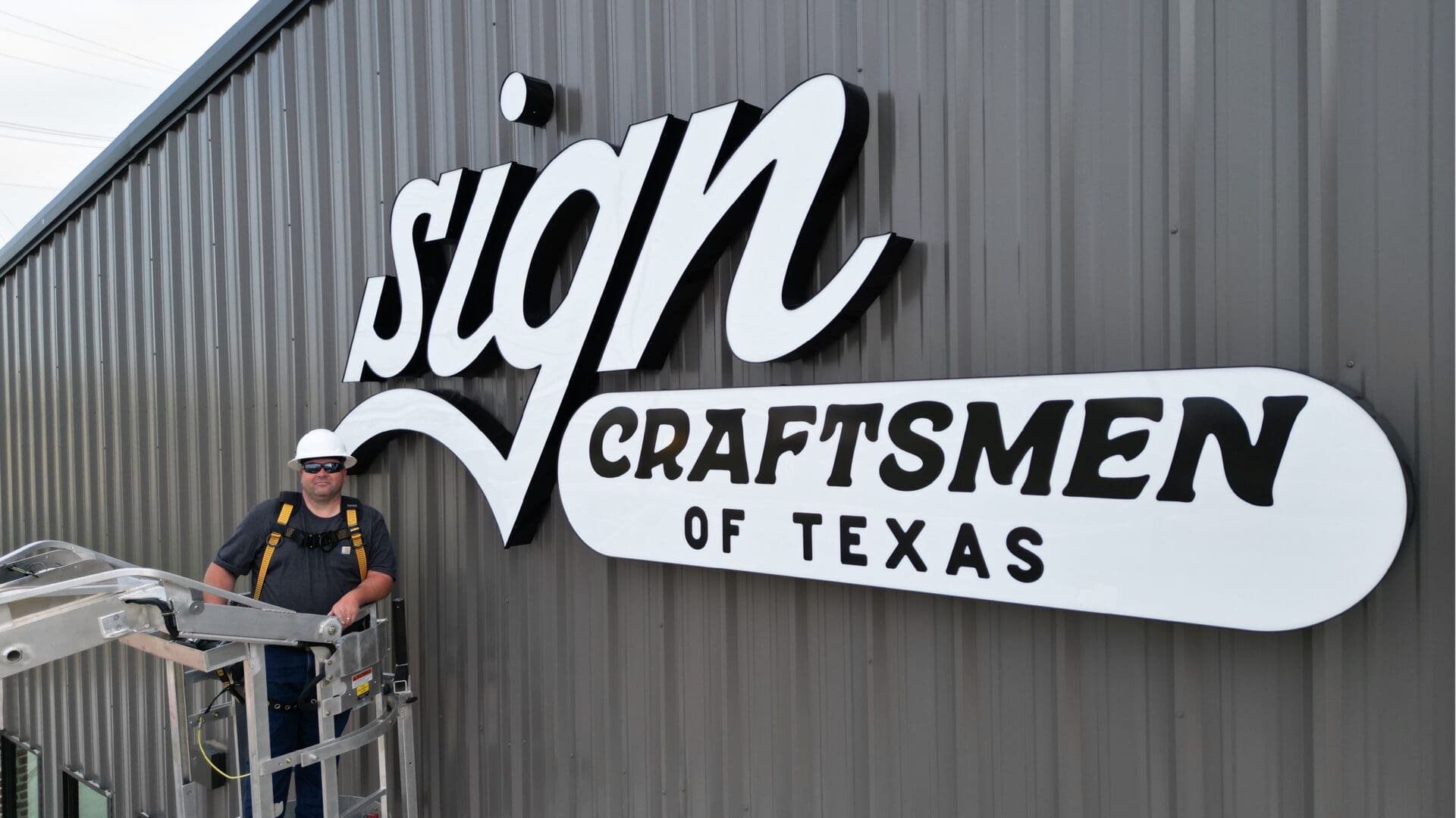 Close-up of illuminated script sign on building