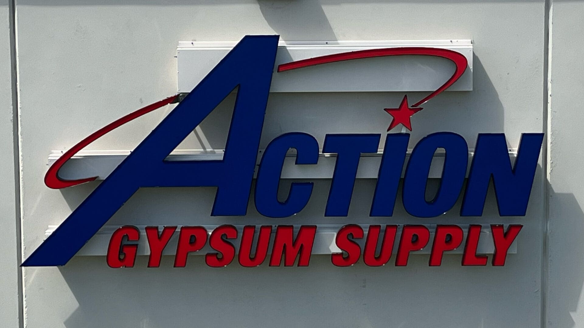 Exterior red and blue Action Gypsum sign