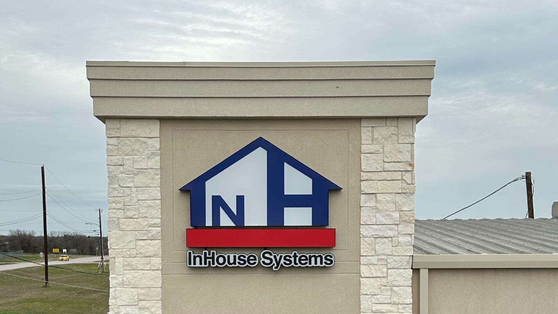 InHouse Systems storefront sign with blue house logo