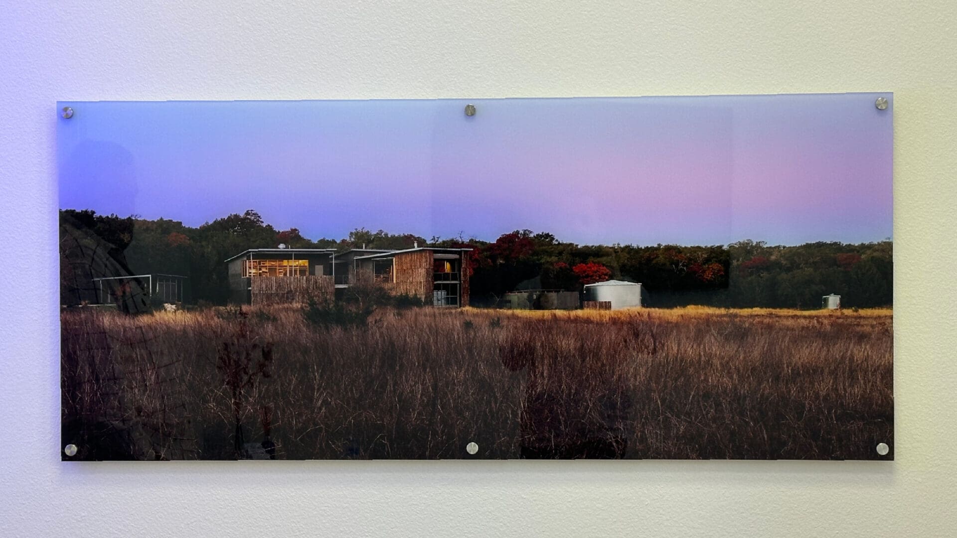 Acrylic panel secured by metal standoffs