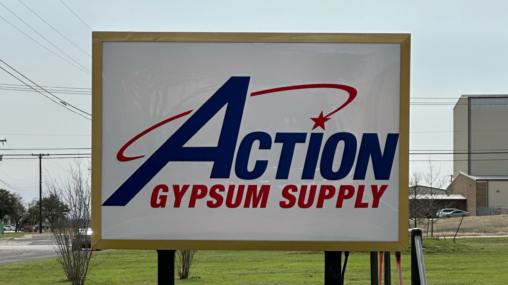 Blue and red Action Gypsum Supply sign